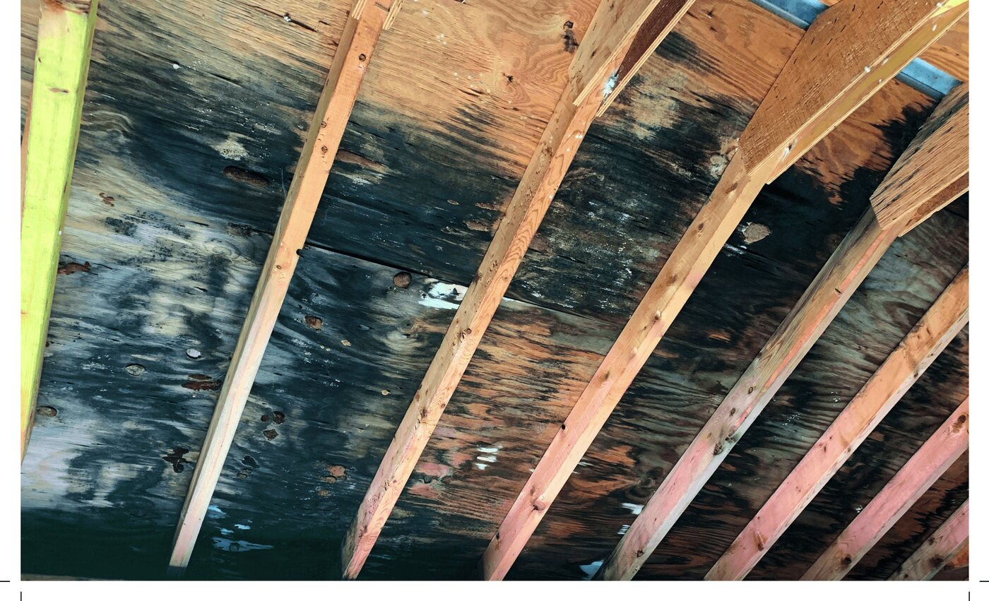 Water staining and deterioration on roof decking found from inside the attic