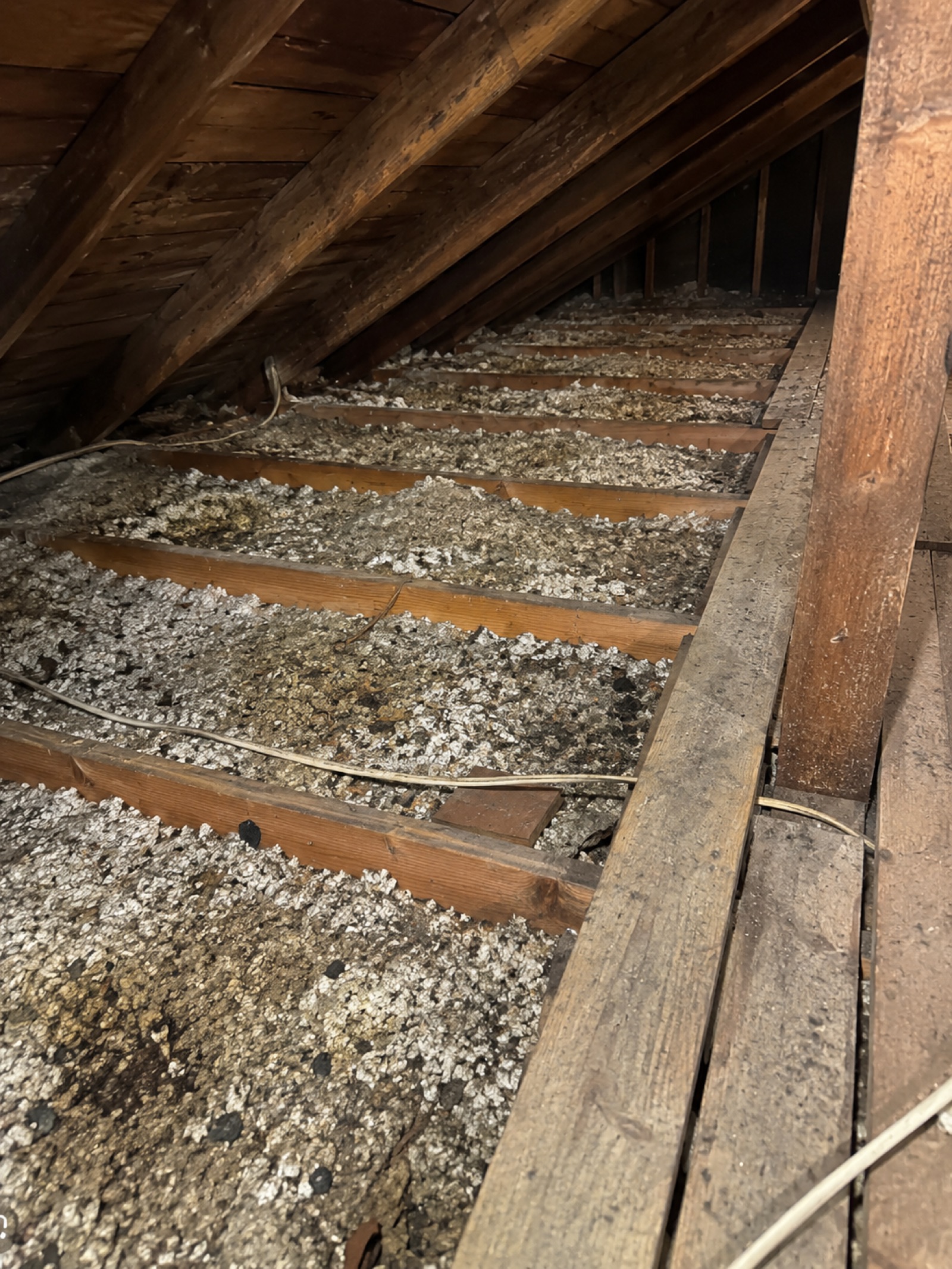 Contaminated, deteriorated attic insulation before removal