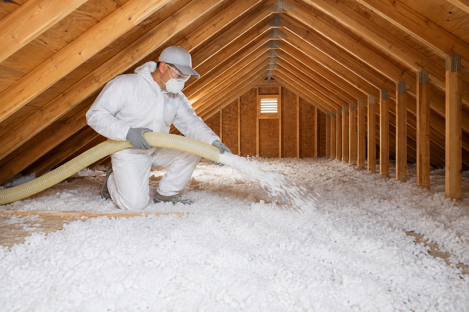 Blown-in insulation refresh being installed in a Texas attic