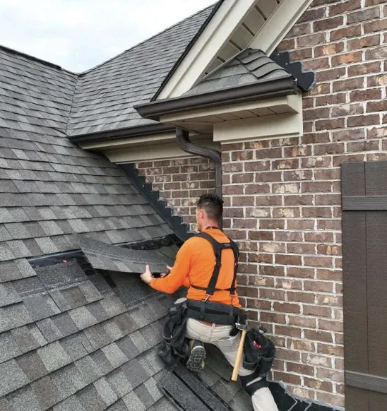 Bearmark roofer inspecting flashing during a roof repair