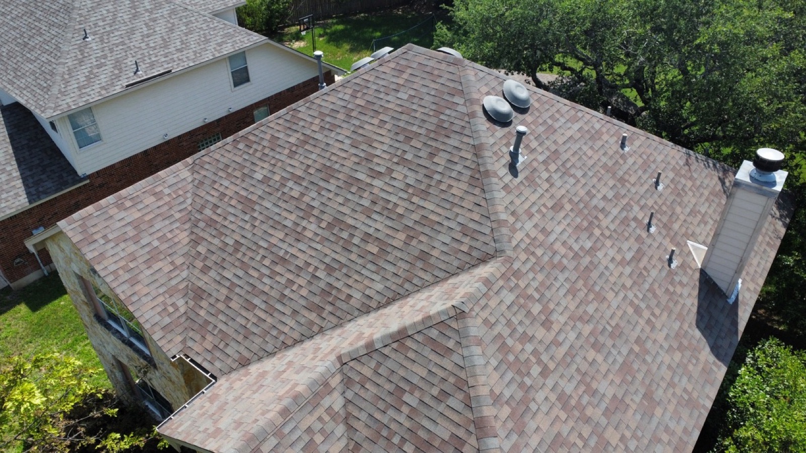 Aerial view of a finished new roof on an Austin home