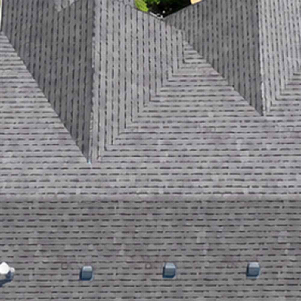 Aerial view of a finished shingle roof with pipe boots and roof accessories sealed