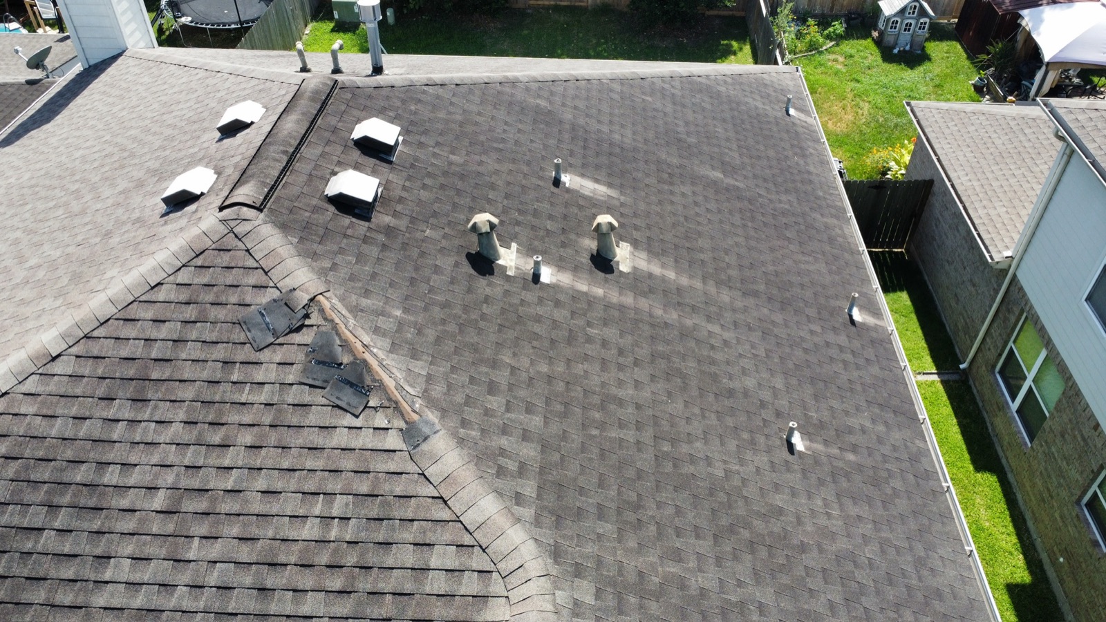 Aerial view of storm-damaged roof shingles