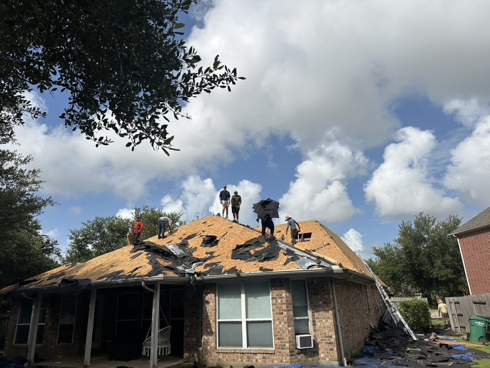 Roof tear-off in progress after storm damage in Houston