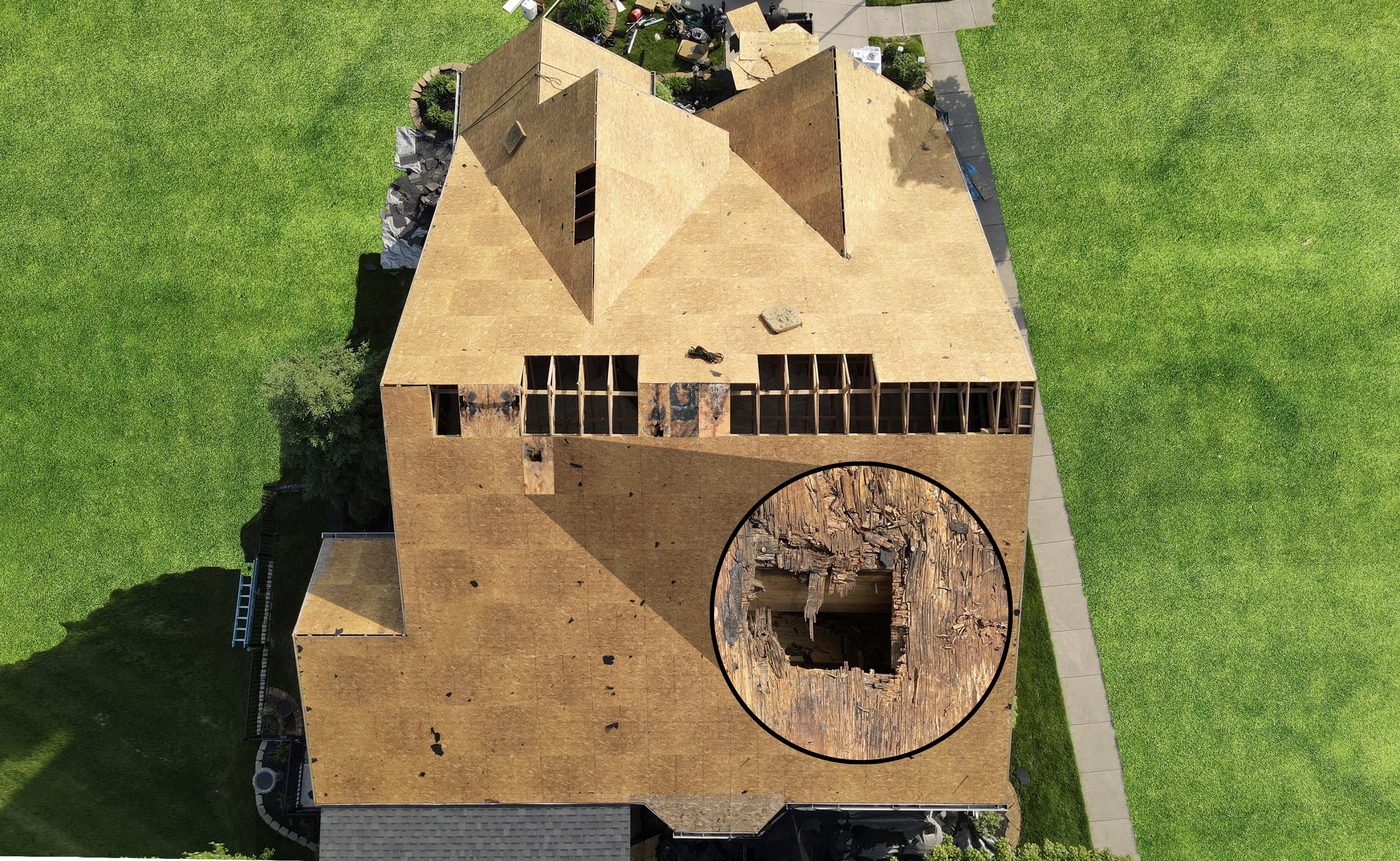 Aerial view of a roof during tear-off with rotten decking exposed