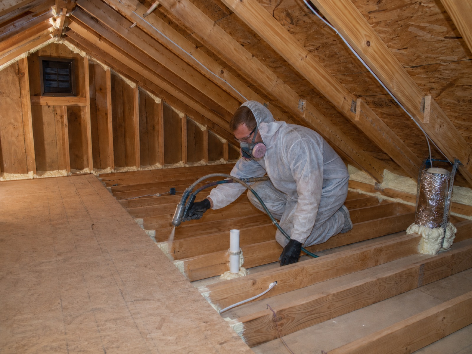 Bearmark technician air sealing attic penetrations