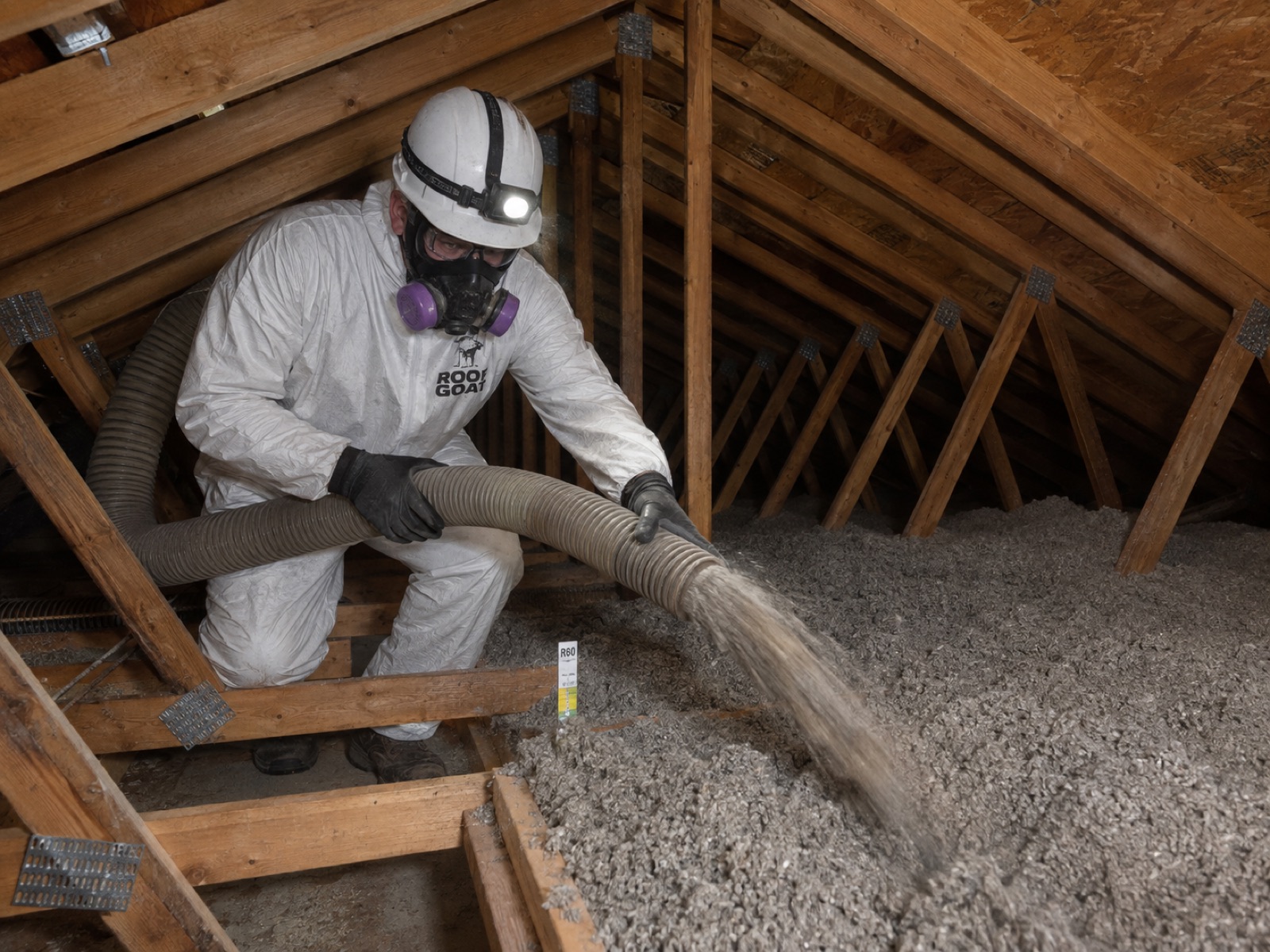 Bearmark technician blowing insulation into a Texas attic